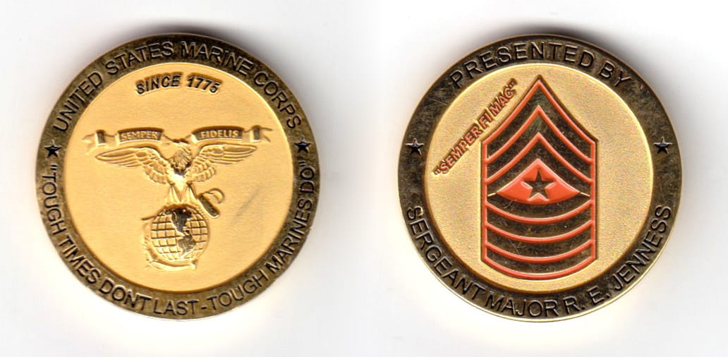 Round shaped coin, brass in color, 1 31/64 inches in diameter.