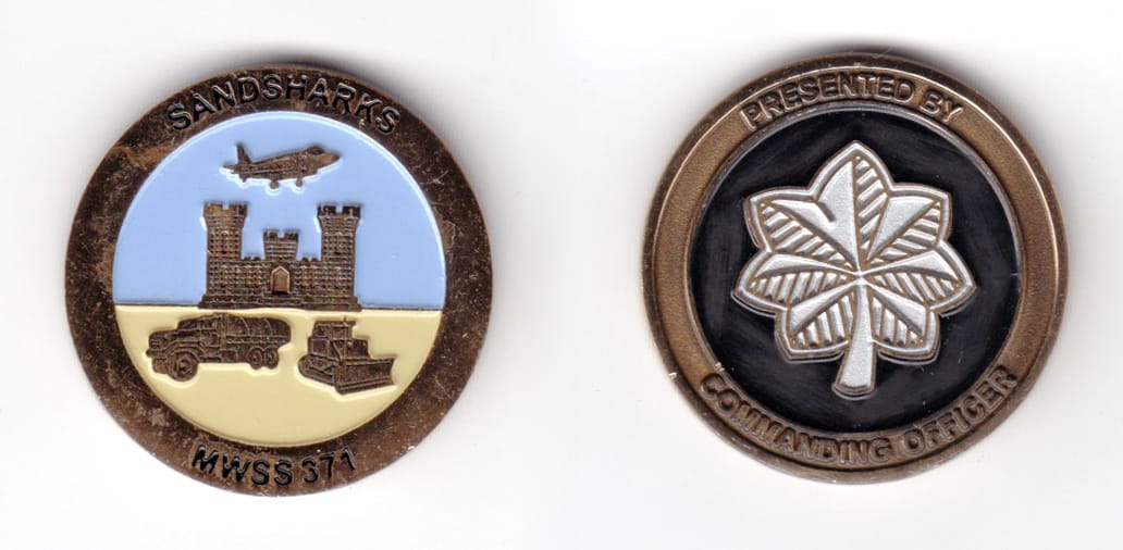 Round shaped coin, brass in color, 1 31/64 inches in diameter.