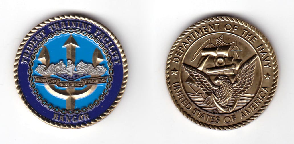 Round shaped coin, brass in color, 1 31/64 inches in diameter.