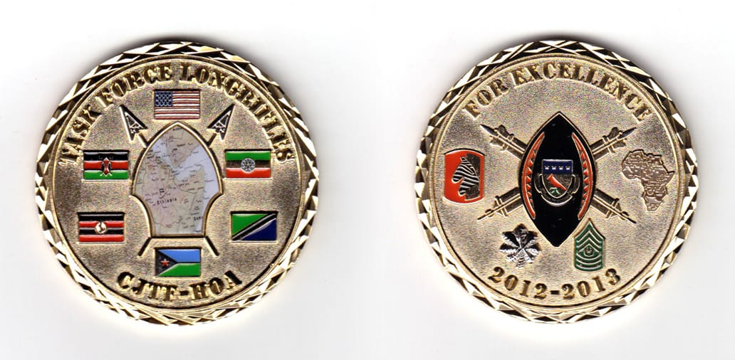 Round shaped coin, brass in color, 1 1/32 inches in diameter.