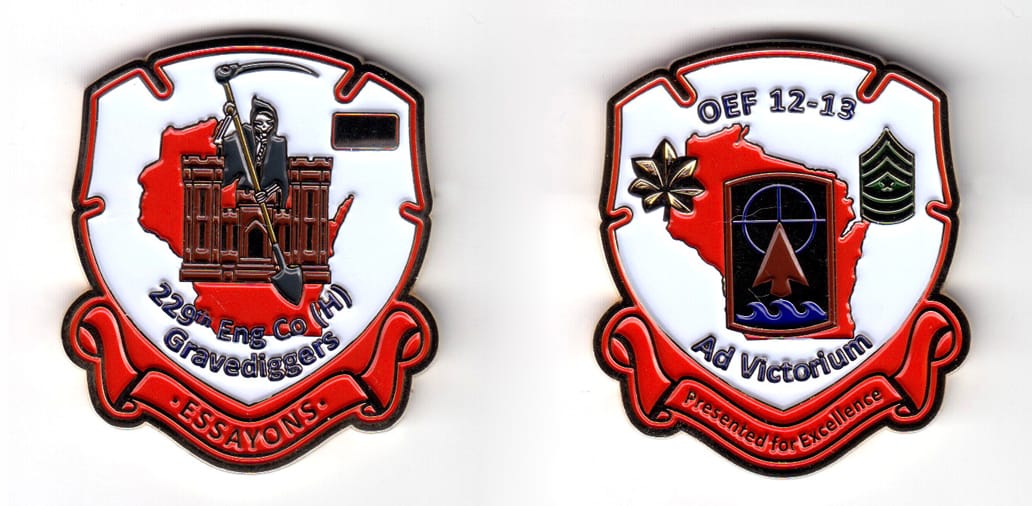 Early 13th century shield shaped coin with ribbon banner under, brass in color, 2 1/64 inches high x 1 43/64 inches wide...