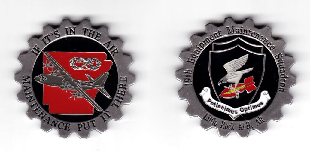 Cog shaped coin, pewter in color, 2 inches in diameter.