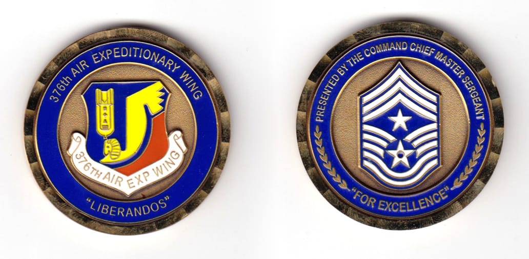 Round shaped coin, brass in color, 1 49/64 inches in diameter.