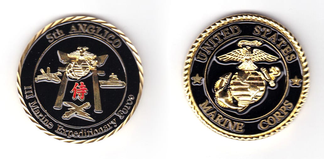 Round shaped coin, brass in color, 1 57/64 inches in diameter.