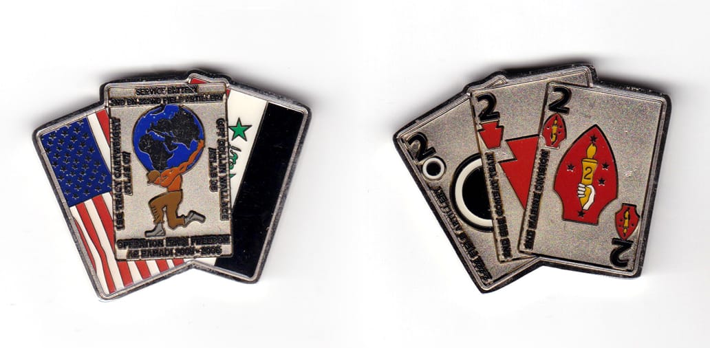 Coin is shaped like a spread hand of playing cards, silver in color, 1 9/16 inches high x 2 inches wide.