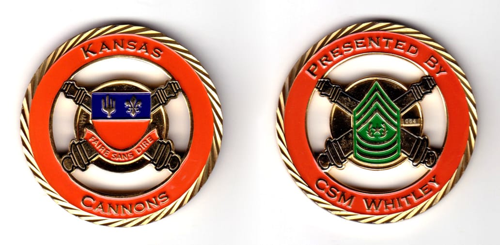 Round shaped coin, brass in color, 2 1/64 inches in diameter.