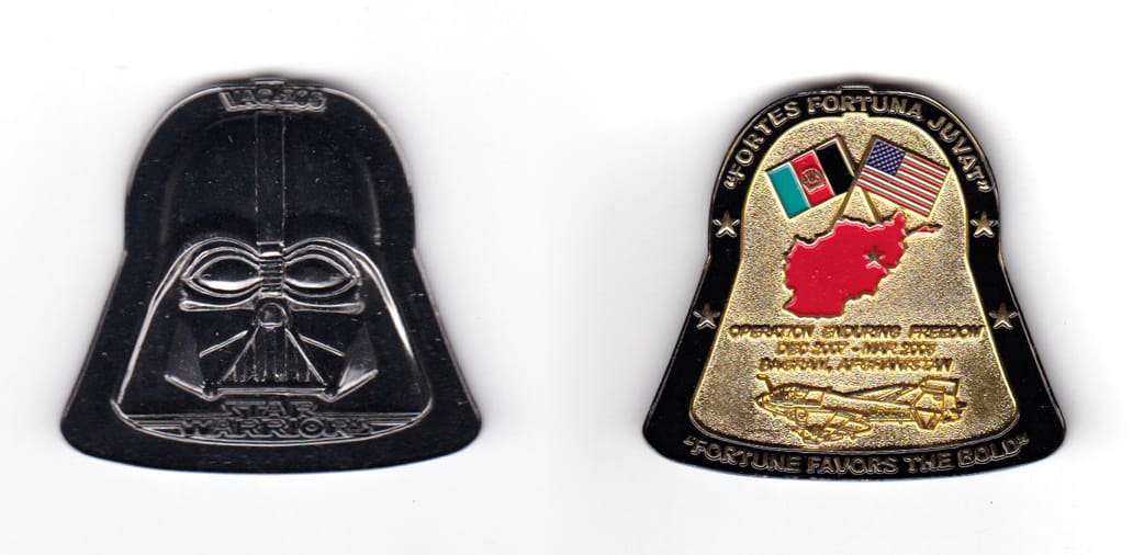 Coin is shaped like the ourline of Darth Vader Head, gunmetal black in color. 1 47/64 inches high x 1 21/64 inches wide.