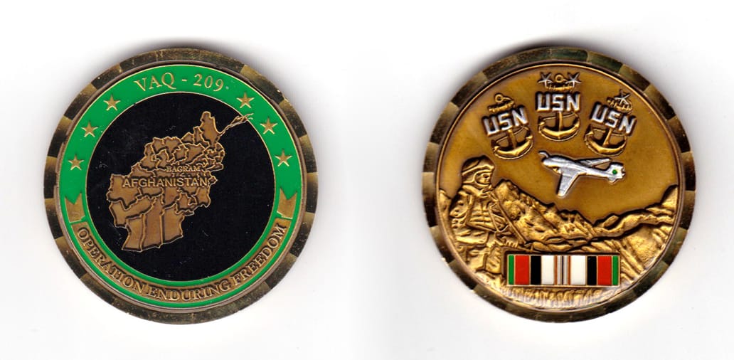 Round shaped coin, brass in color, 1 47/64 inches in diameter.