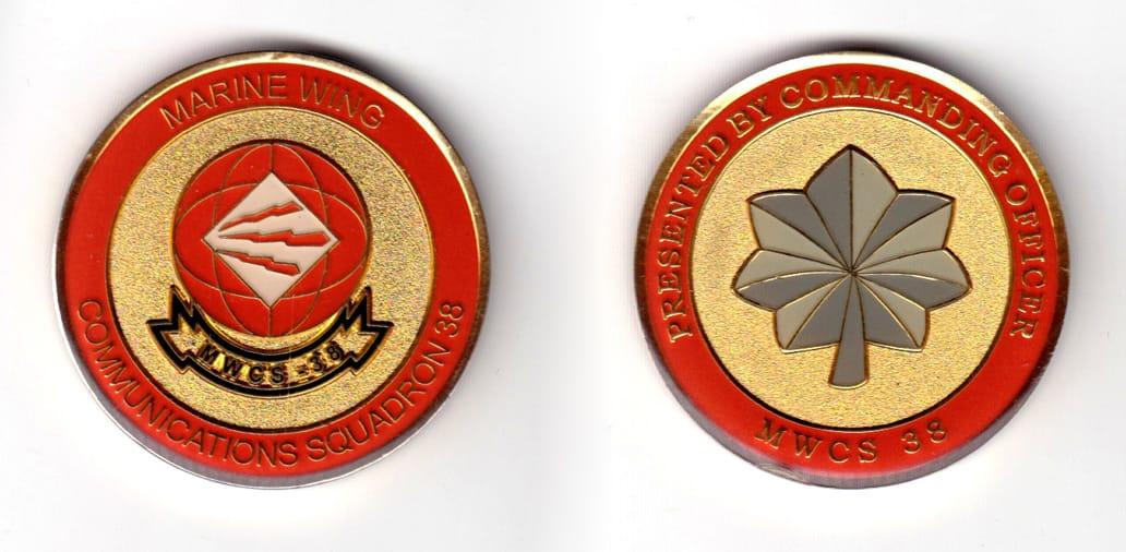 Round shaped coin, brass in color, 1 49/64 inches in diameter.