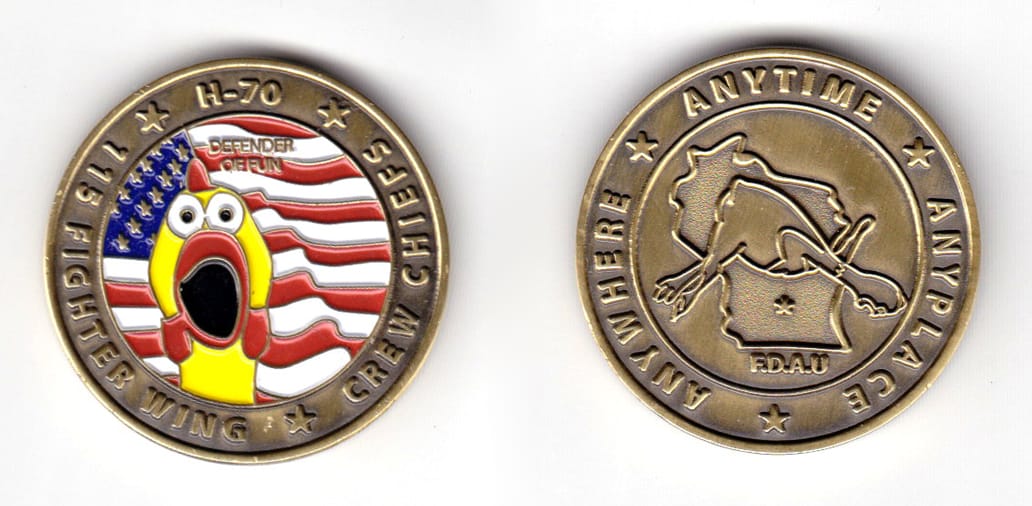 Round shaped coin, brass in color, 1 31/64 inches in diameter.