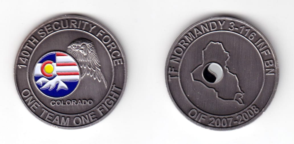 Round shaped coin, pewter in color, 1 1/2 inches in diameter.