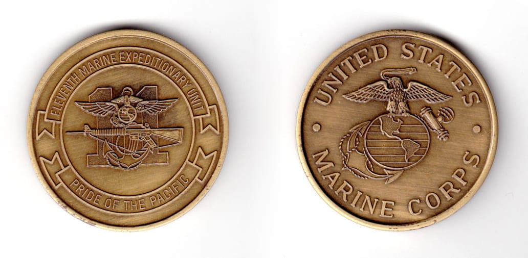 Round shaped coin, antique brass in color, 1 47/64 inches in diameter.