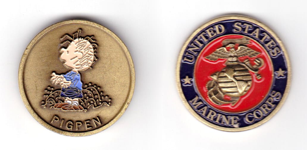 Round shaped coin, brass in color, 1 39/64 inches in diameter.