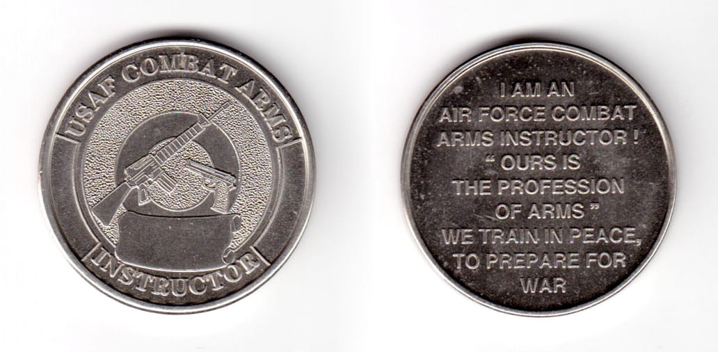 Round shaped coin, pewter in color, 1 19/32 inches in diameter.