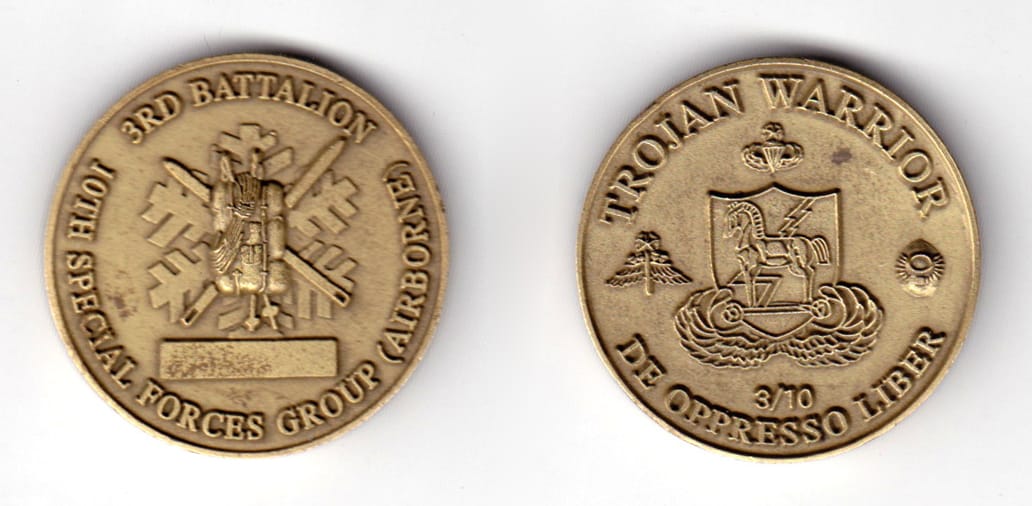 Round shaped coin, antique brass in color, 1 9/16 inches in diameter.