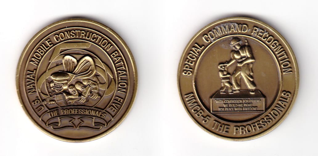 Round shaped coin, brass in color, 1 51/64 inches in diameter.