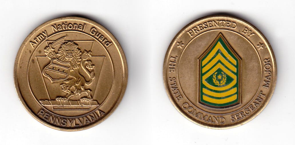 Round shaped coin, antique brass in color, 1 17/32 inches in diameter.