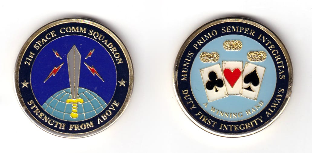 Round shaped coin, brass in color, 1 43/64 inches in diameter.