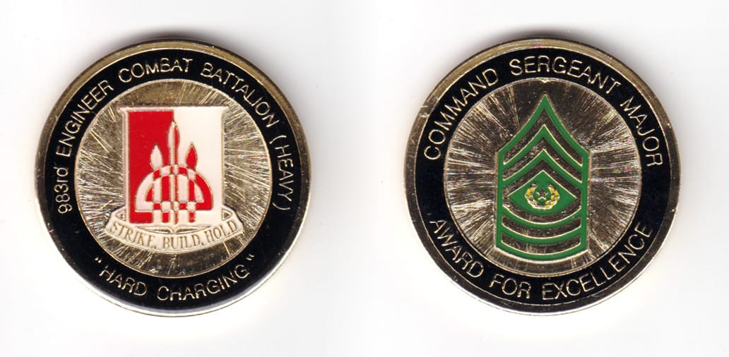 Round shaped coin, brass in color, 1 43/64 inches in diameter.