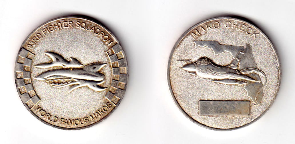 Round shaped coin, pewter in color, 1 43/64 inches in diameter.