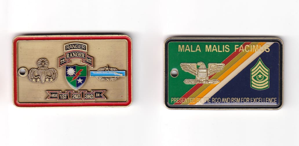 Rectangular shaped coin, brass in color, 1 33/64 inches high x 2 1/2 inches wide.