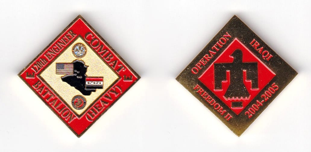 Square shaped coin angle down, brass in color, 1 33/64 inches high x 1 33/64 inches wide.