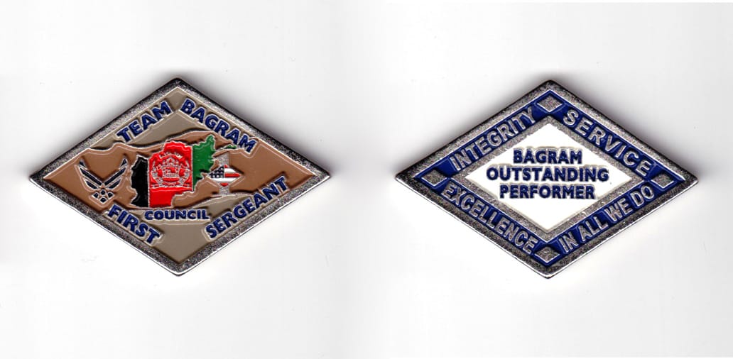 Diamond shaped coin, pewter in color, 1 9/16 inches high x 2 25/64 inches wide.