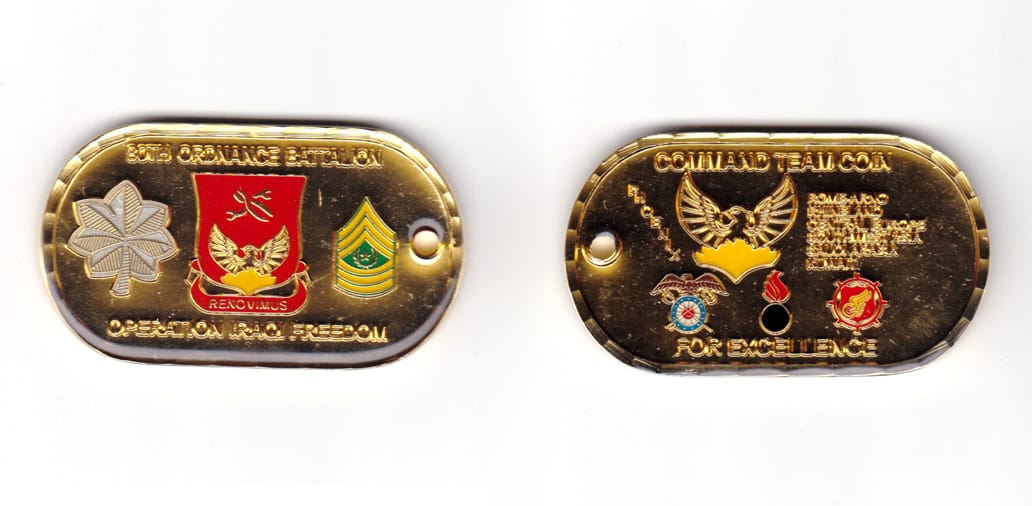 Dog tag shaped coin brass in color, 1 7/16 inches high x 2 33/64 inches wide.