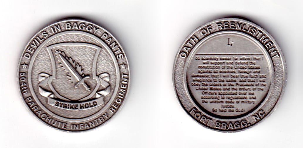 Round shaped coin, pewter in color, 1 37/64 inches in diameter.