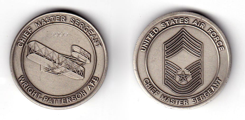 Round shaped coin, pewter in color, 1 35/64 inches in diameter.