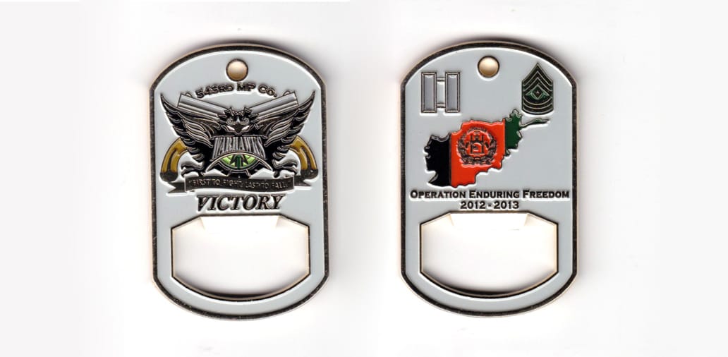 Dog tag shaped bottle opener, brass in color, 2 17/32 inches high x 1 3/64 inches wide.