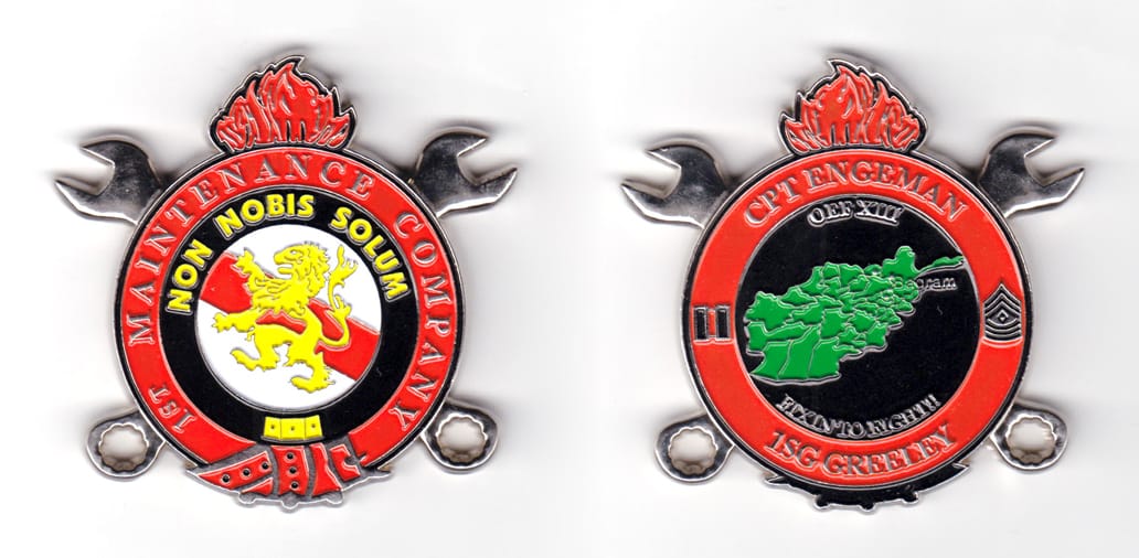 Round shaped coin with pisspot flame above, crossed combination wrenches behind and ribbon ends below; silver in color, ...