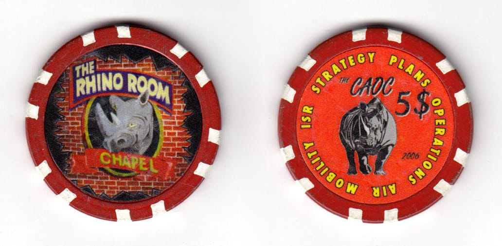 Round shaped poker chip, maroon and white, 1 35/64 inches in diameter.