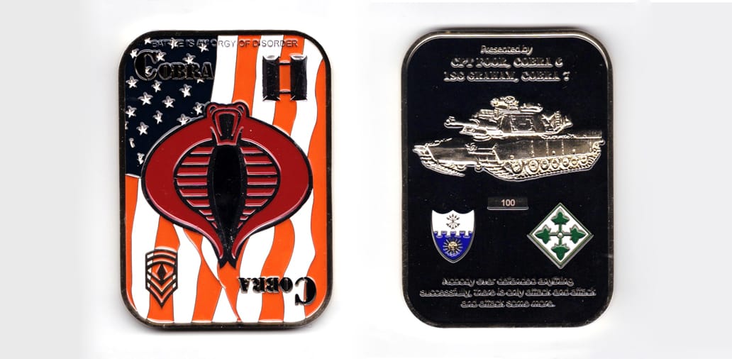 Rectangular shaped coin with rounded corners, brass in color, 3 1/2 inches high x 2 1/2 inches wide.