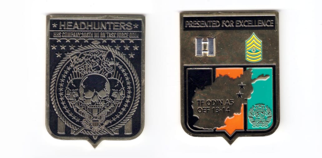 Shield shaped coin, Brass in color, 3 inches high x 2 1/4 inches wide.