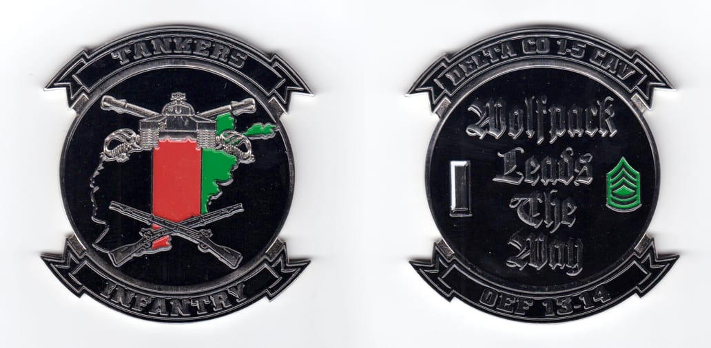 Round shaped coin, silver in color, with ribbon banners above and below, 3 inches high x 2 3/4 inches wide.