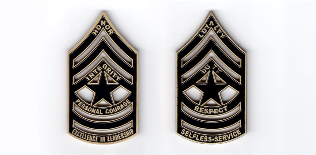 Coin is shaped like a Sergeant Major's Rank Insignia, antique brass in color, 3 1/2 inches high x 2  inches wide.