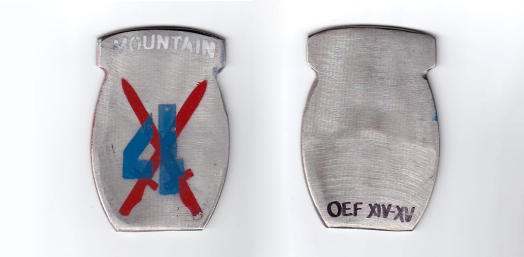 Olla shaped coin, pewter in color, 3 1/8 inches high x 2 1/8 inches wide.