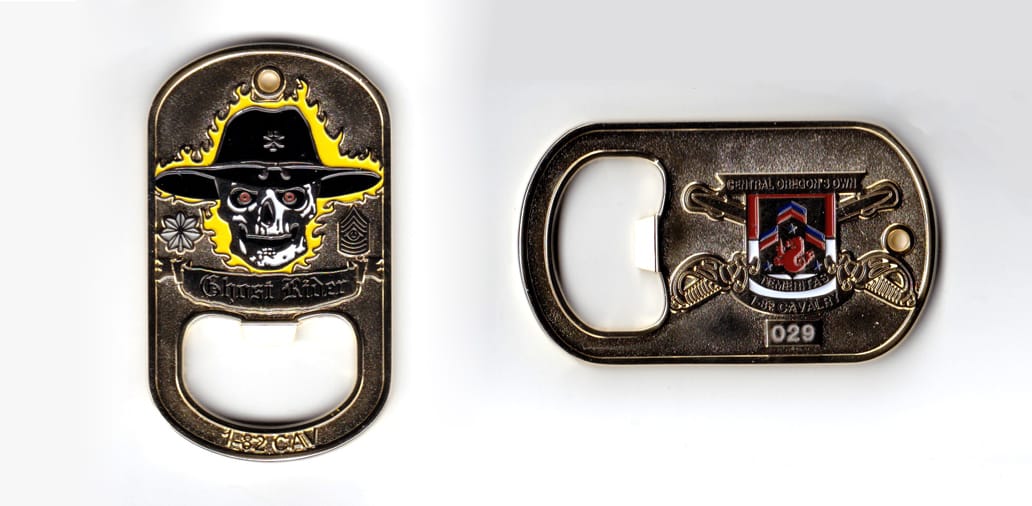 Dog tag shaped coin, brass in color, 2 1/2 inches high x 1 1/2 inches wide.