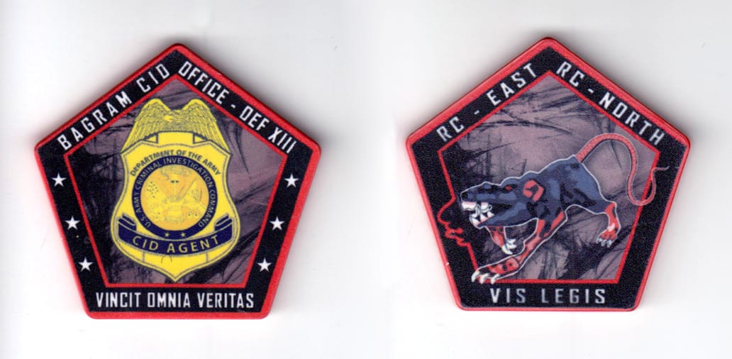 Pentagon shaped poker chip, red and black in color, 1 15/16 inches high x 2 1/16 inches wide.