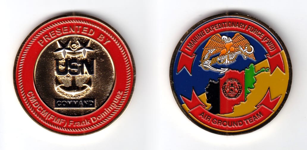 Round shaped coin brass in color, 2 inches in diameter.