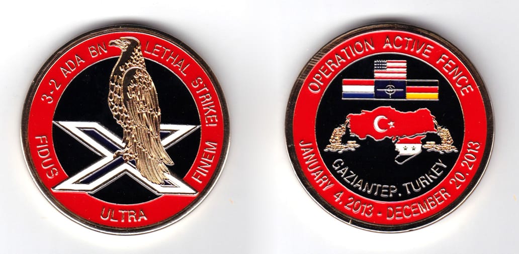 Round shaped coin, brass in color, 2 inches in diameter.