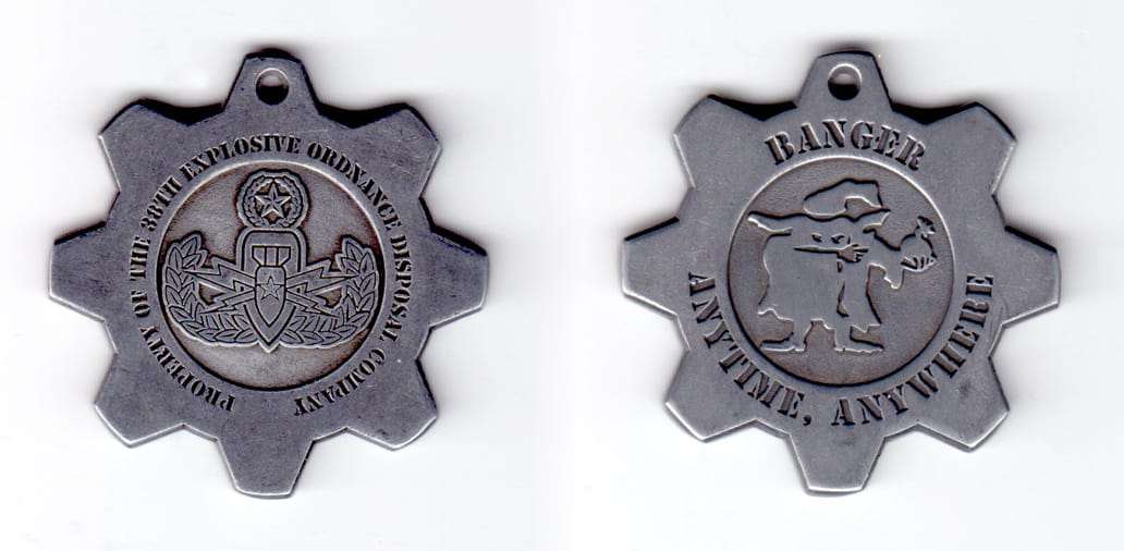 Cogwheel shaped coin, lead in color, 1 3/4 inches in diameter.