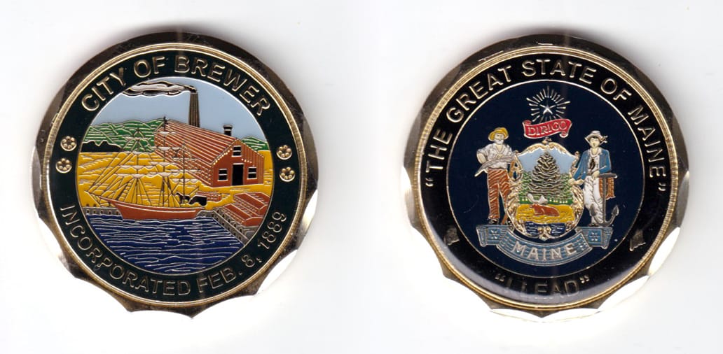 Round shaped coin, brass in color, 1 3/4 inches in diameter.