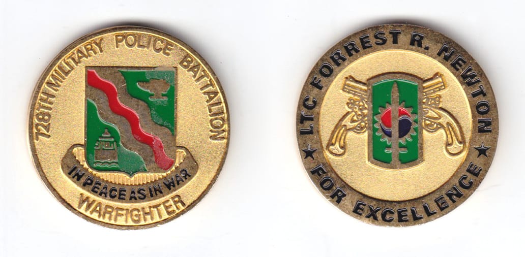 Round shaped coin, brass in color, 1 1/2 inches in diameter.