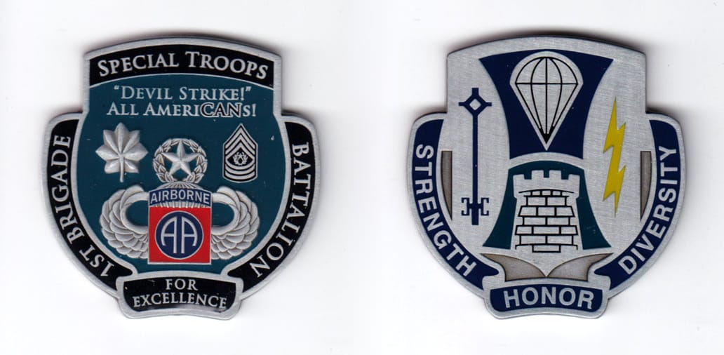 Shield shaped coin with banners all around, pewter in color, 2 1/4 inches high x 2 1/4 inches wide.