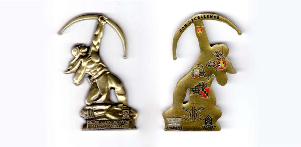 Coin shaped like a Native American with one knee on the gound and shooting a bow at a high angle, antique brass in color...