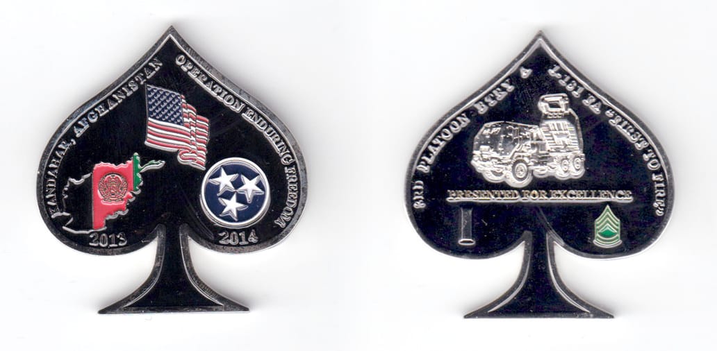 Spade shaped (playing cards) coin, silver in color, 2 inches high x 
1 7/8 inches wide.