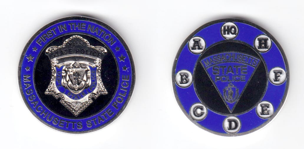 Round shaped coin, silver in color, 1 1/2 inches high.