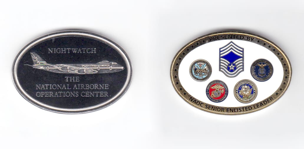 Oval shaped coin, silver in color, 1 1/2 inches high x 2 inches wide.